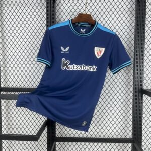 Camiseta visitante Athletic Club 2025‑26 en azul marino con detalles en turquesa, escudo bordado y cuello redondo