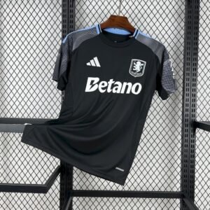 Camiseta visitante Aston Villa 25/26 negra con detalles azul grisáceo y logotipos plata, estampado circular inspirado en Bullring